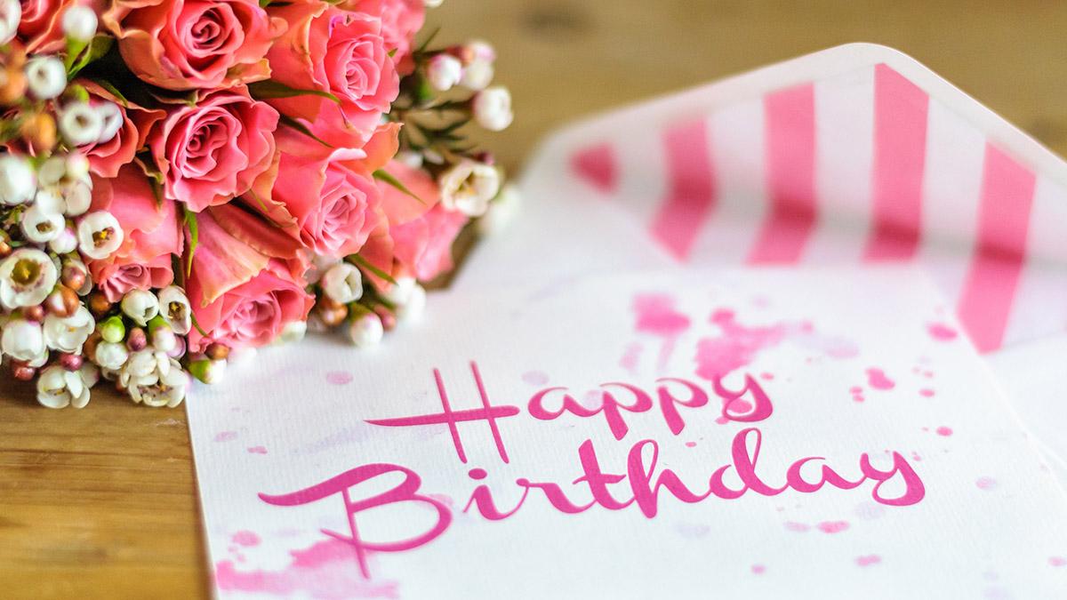 Happy birthday greeting card with pink flowers