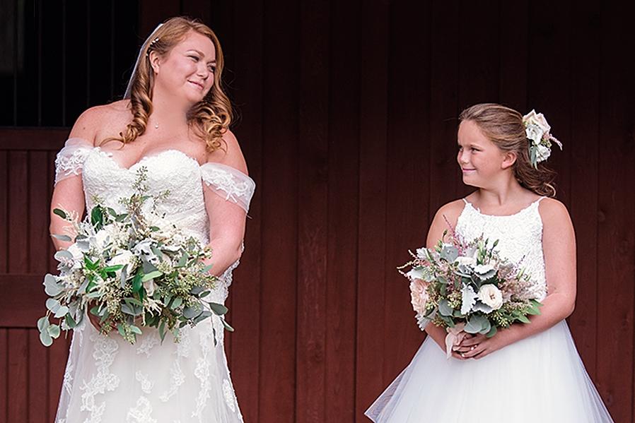 Bride and flower girl holding wedding bouquets