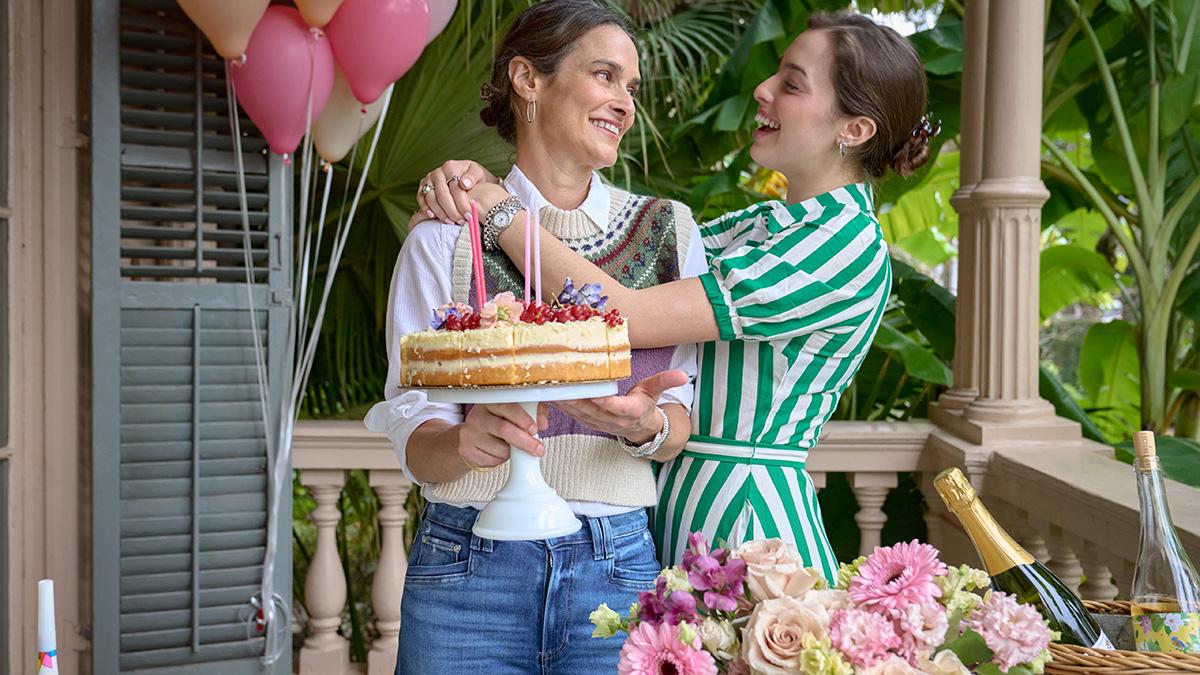 Two women celebrating a birthday on a front porch.